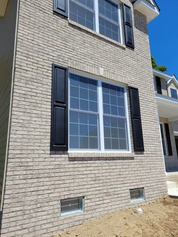 Light brick with dark shutters