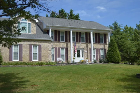 Brick with a columned porch